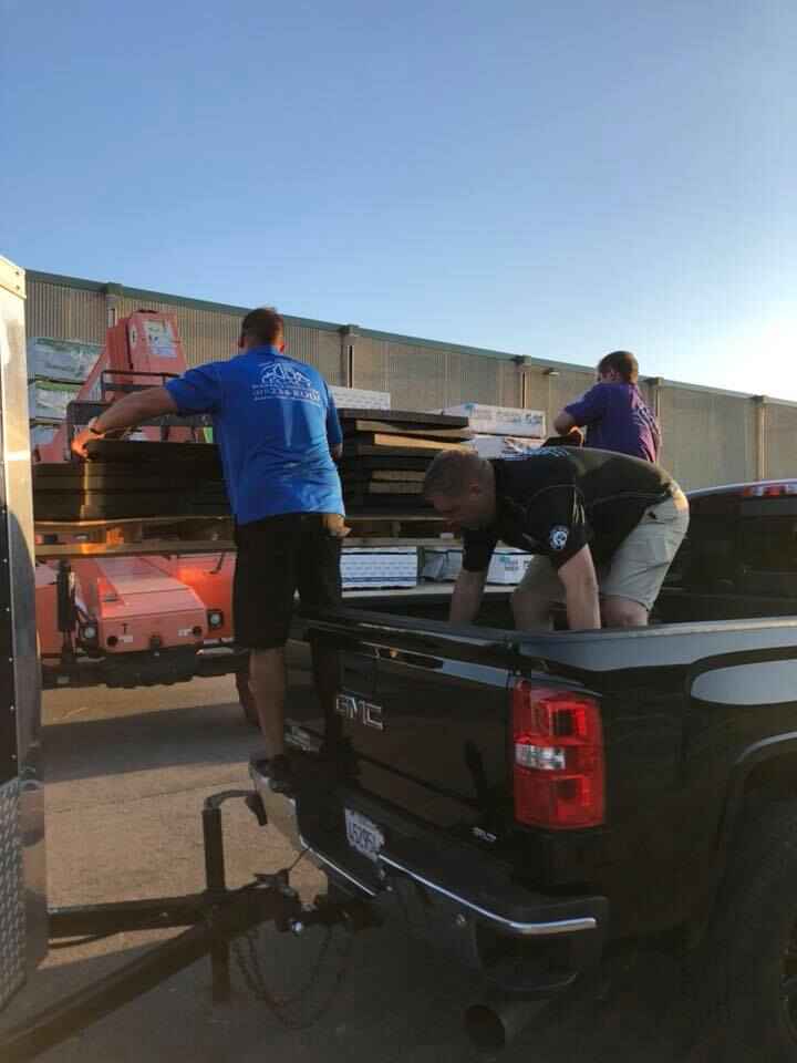 Legacy Roofing & Solar team members loading materials on truck