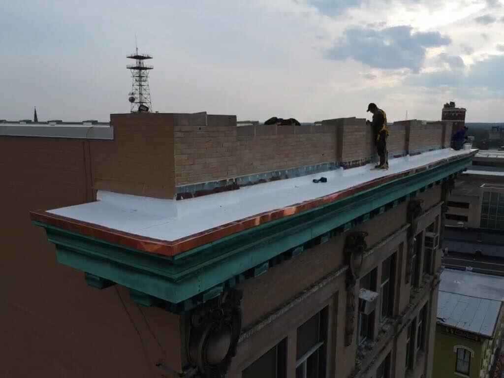 men working on apartment roof