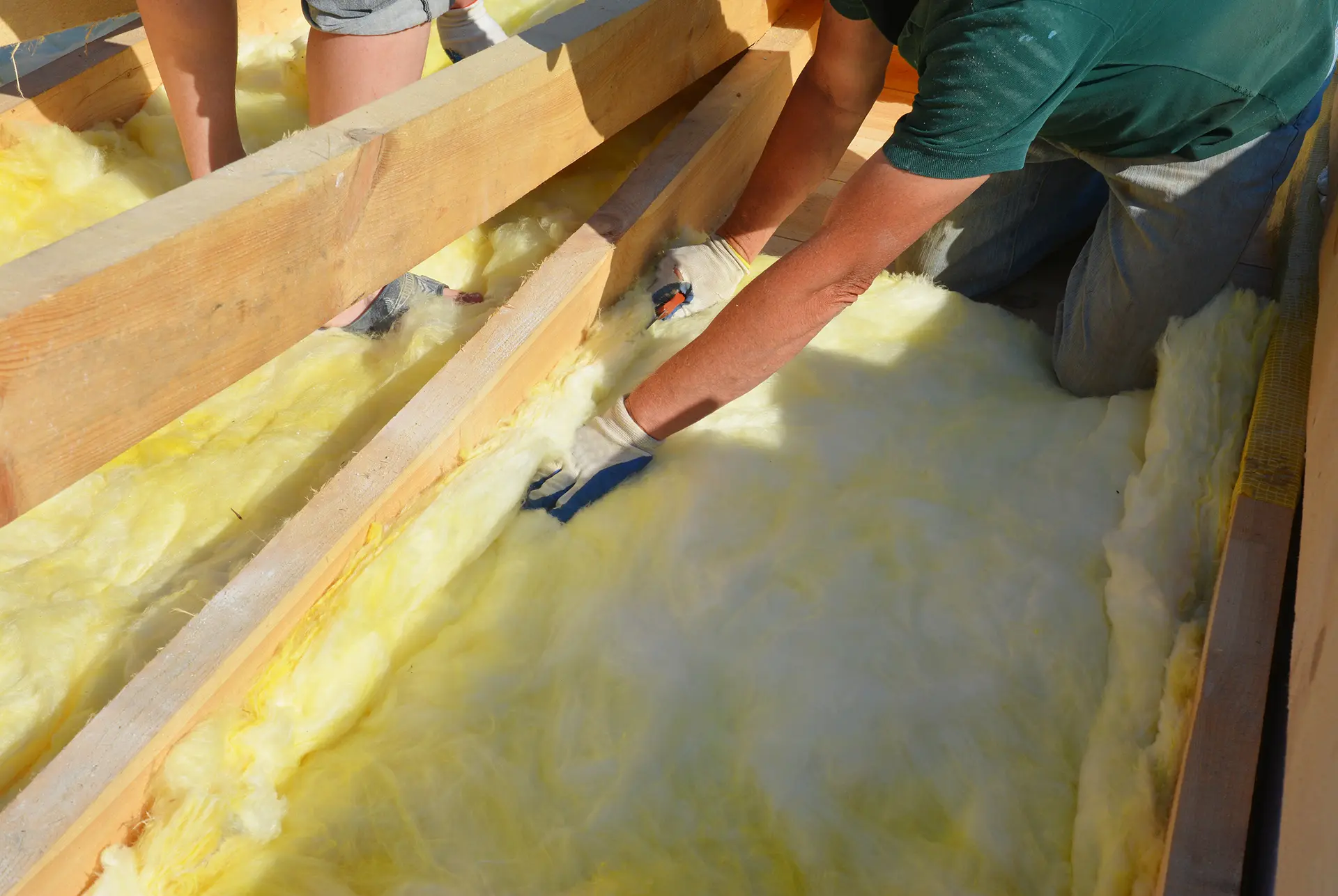 Technician applying batt insulation